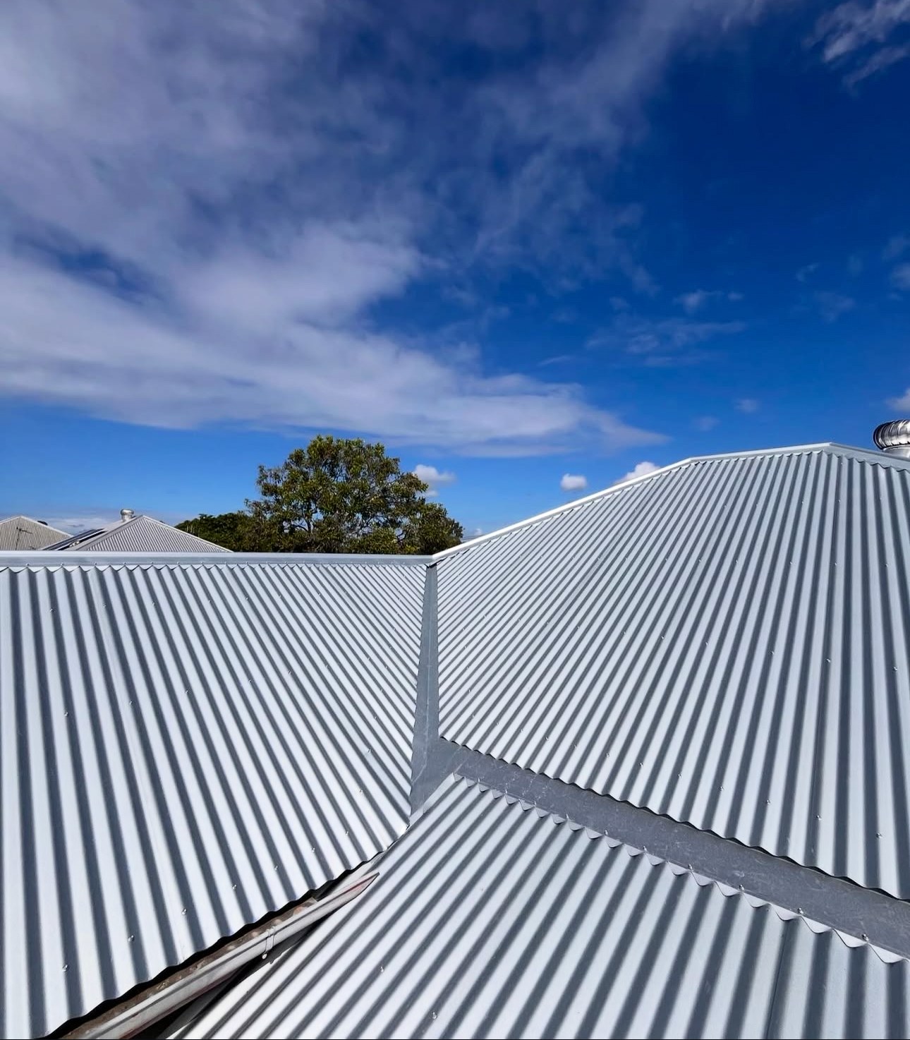 Corrugated metal roof with new ridge capping