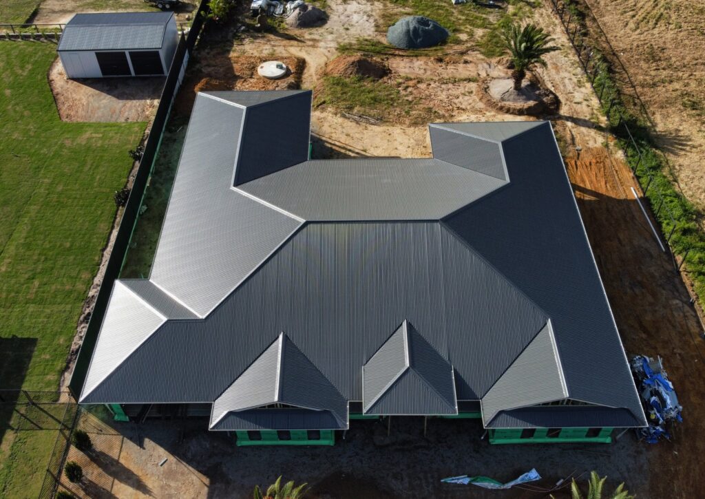 Aerial view of a dark metal roof on a new Sunshine Coast home