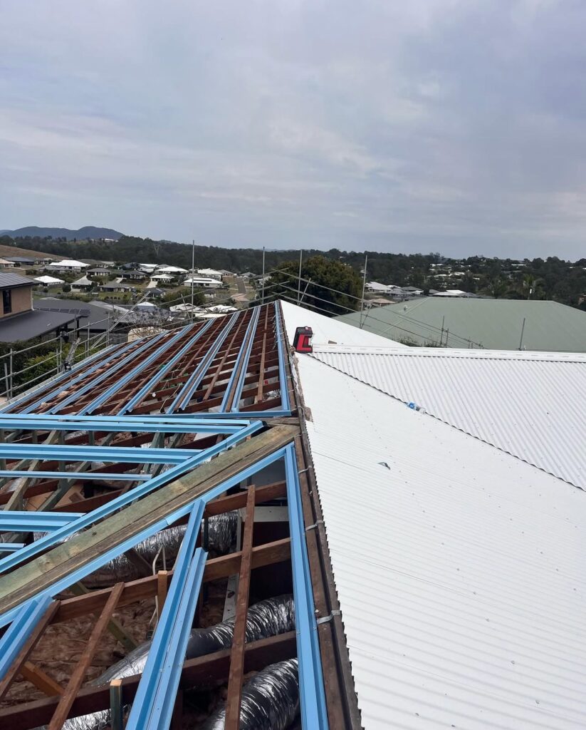 New build roof with steel frame and metal sheeting being installed