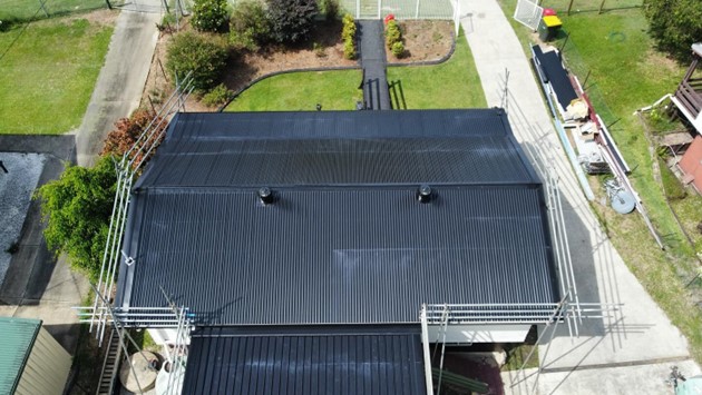 Dark metal re-roof, aerial view, Sunshine Coast roofing by Young Gunns Roofing